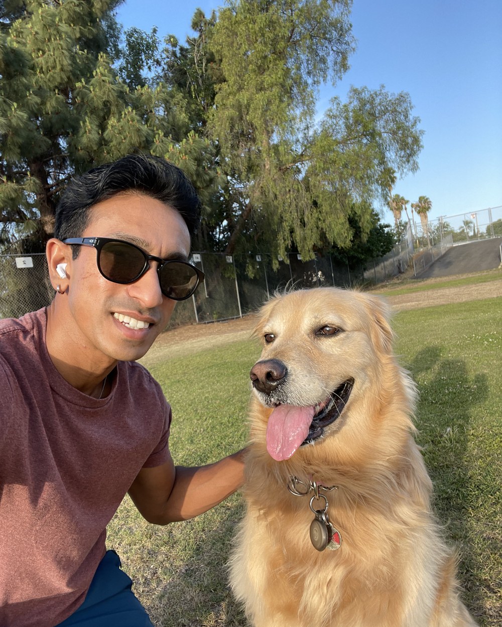 Shreyas with his golden retriever at the park